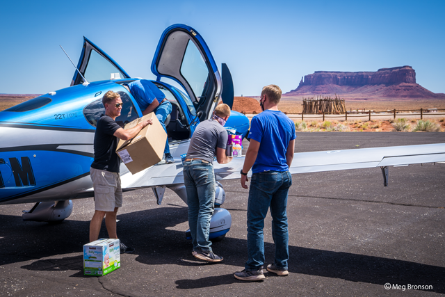 Najajo nation relief project grabbing supplies from airplane