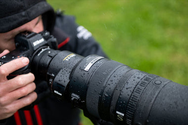 photographer with new Nikon 600m f/4 TC VR lens in the rain