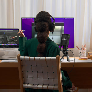 woman recording at desk in home