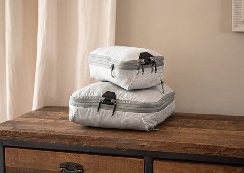 peak design packing cubes on wood dresser