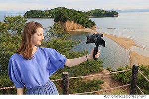 woman vlogging on a cliff side