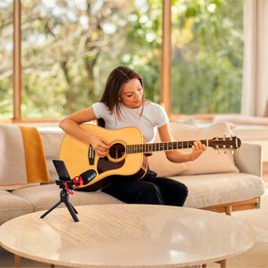 woman playing guitar recording herself with phone and Rode videomicro II