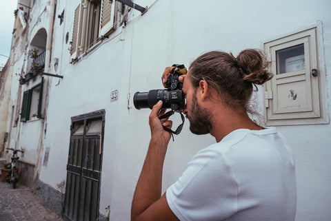man taking picture in alley