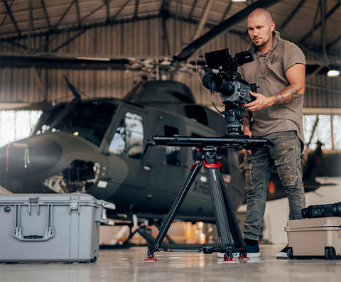 videographer with slider on sachtler tripod and sony cinema camera