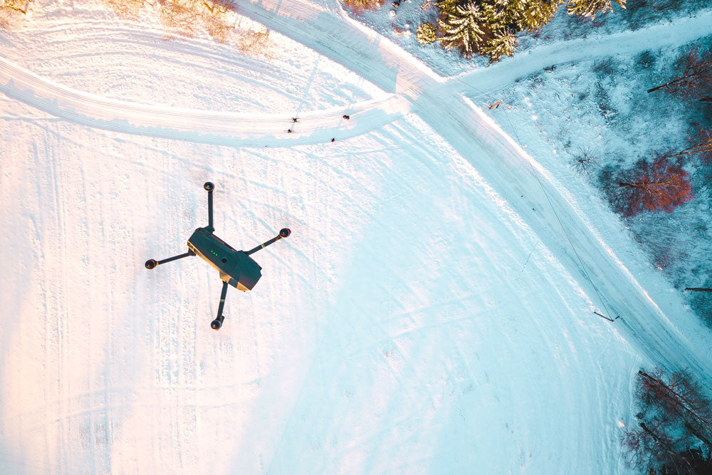 Drone flying above snowy conditions 