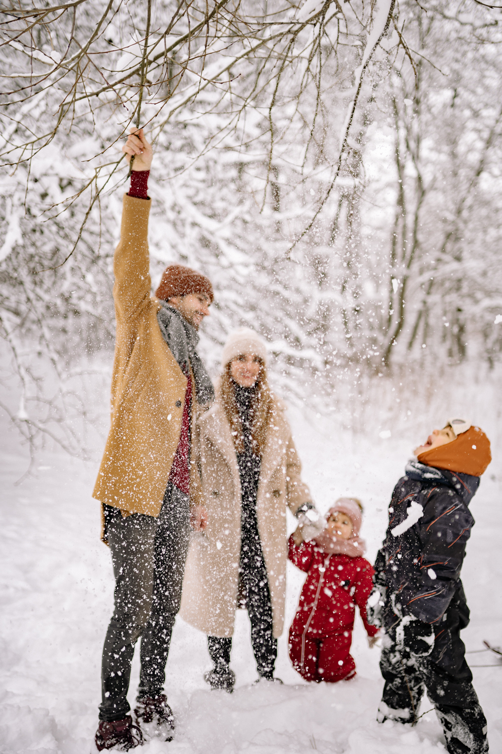 family playing in the snow