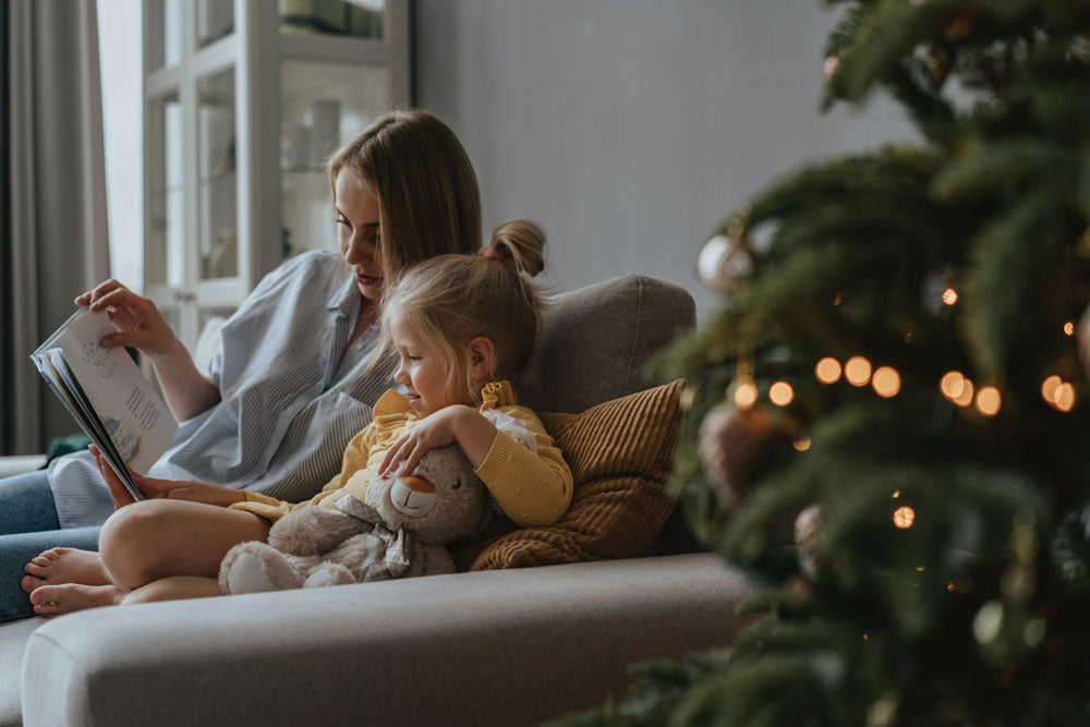 mom reading to daughter during christmas time