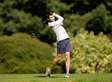 Man swinging a golf club