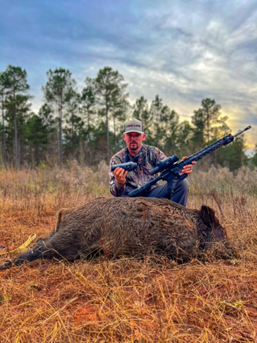 man posing with thermal optic after hunt