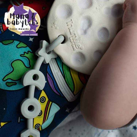 Squiggle Strap toy strap attached to a Moon shaped teething toy by Thumble Baby Care