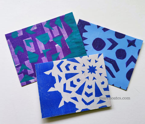 Winter cards made with paper snowflakes as a mask