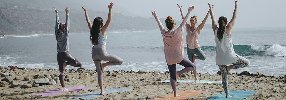 A group of woman practicing Yoga together