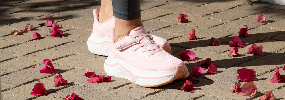 Woman walking with pretty pink adaptive sneakers