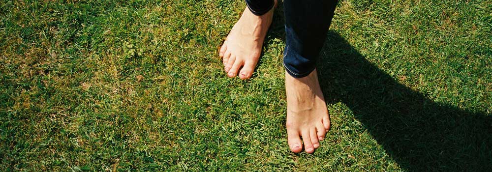Feet of a person standing on lawn