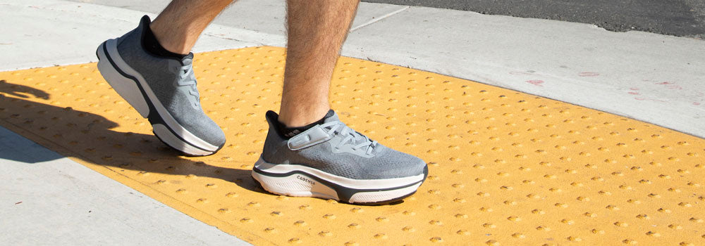 Guy walking with adaptive slate colored sneakers