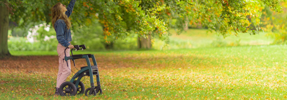 Young Woman using a walker to get around in a beautiful spring environment