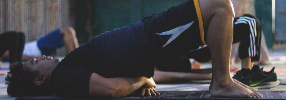 Young man doing a glute bridge exercise