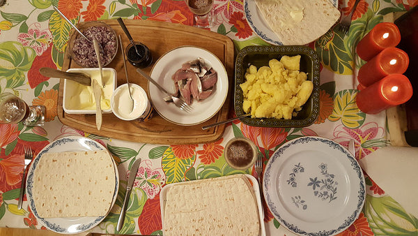 Surströmming dinner prepared with potato and thin bread