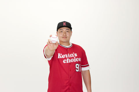 jiman choi with a baseball on hand with Kevins choice uniform