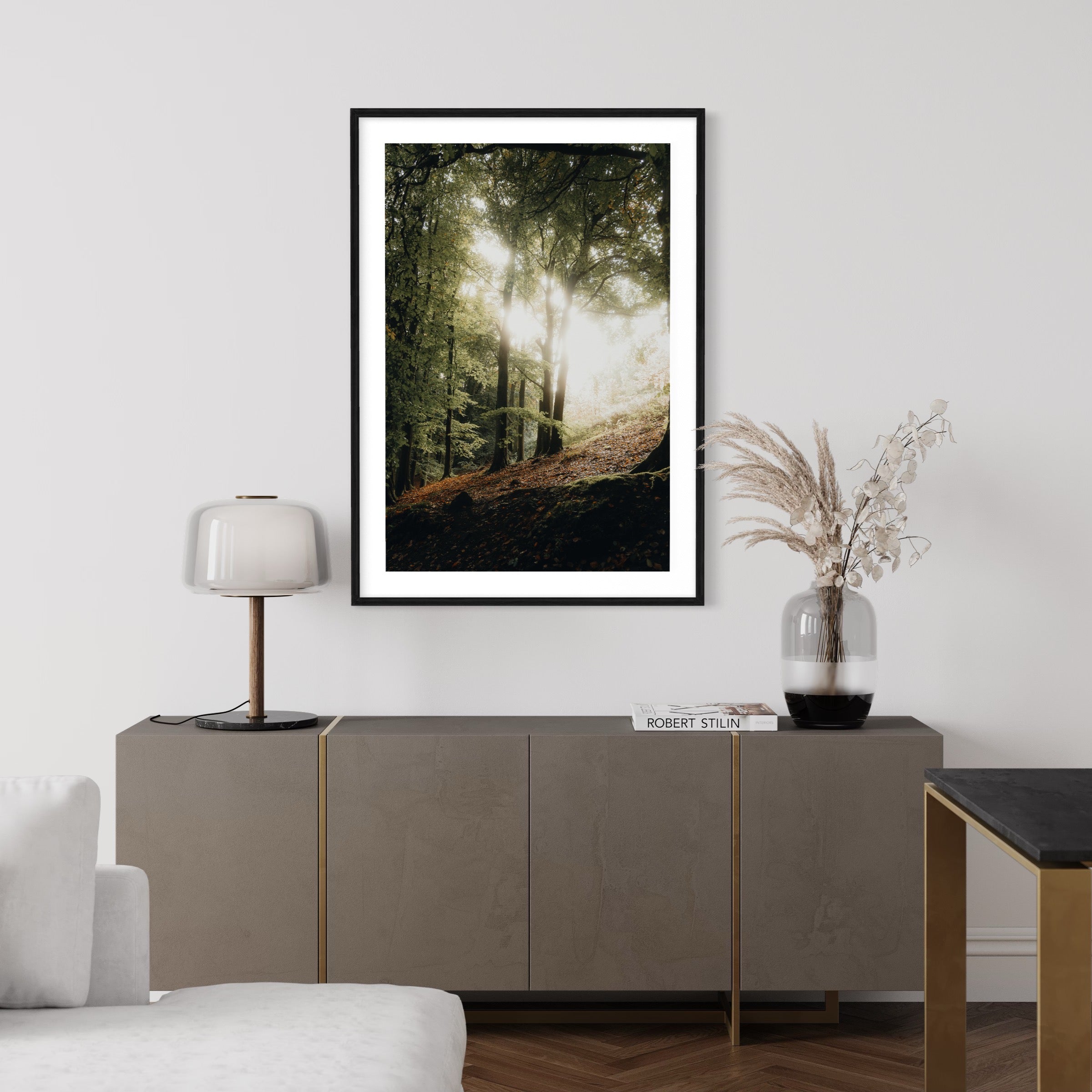 Wall art print of the sunrise seeping through trees in a forest.