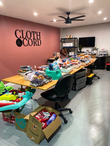 Ellana Kone, owner of Cloth & Cord getting items ready to be packed for kids in the foster system.