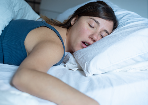 a woman snoring as she sleeps 