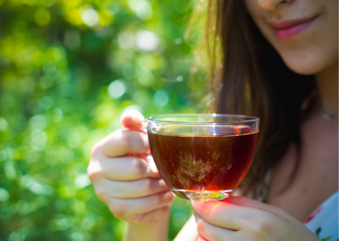 a woman drinking black tea for its health benefits