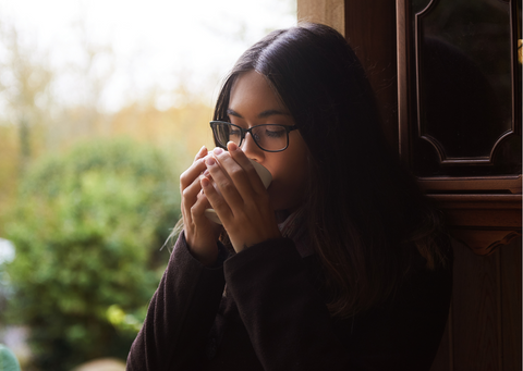 a woman casually drinking tea