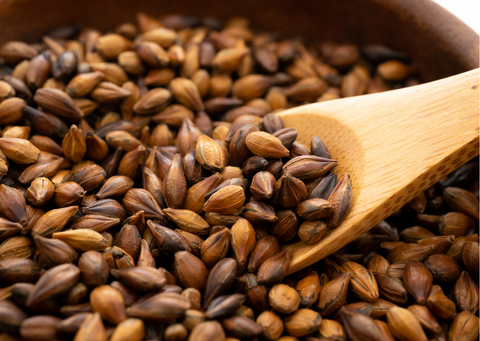 scooping roasted barley for tea