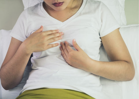 a woman experiencing heartburn