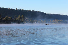 Fisherman on lake with steam