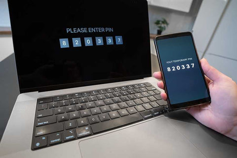 Laptop and smartphone together showing the two-factor authentication process