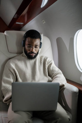 digital nomad working on their laptop during long haul flight