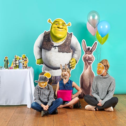 A group of people wearing Shrek cardboard Face Masks