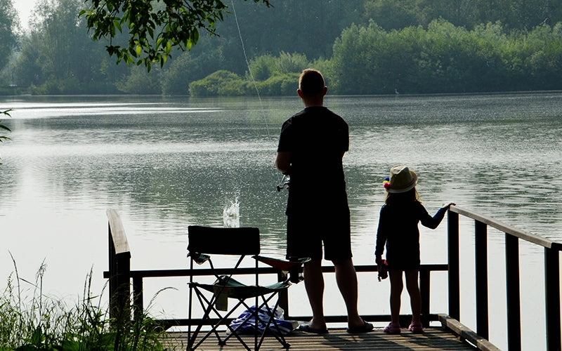 Father and daughter fishing on a lake