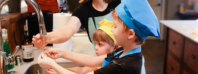 Kids washing their hands ready to cook