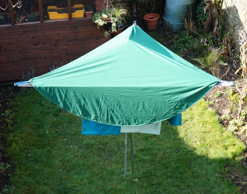 Laundry on the line protected from rain by a laundry mac