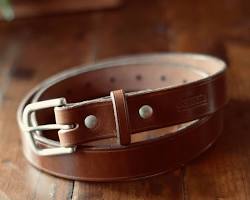 Close-up photo of a brown leather belt with pre-drilled holes