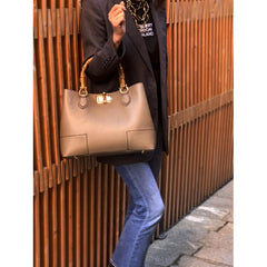 A woman carrying a high-quality Italian leather tote bag