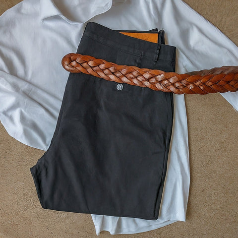 White business shirt with black pants and braided caramel belt