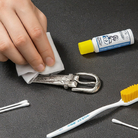 Image of someone cleaning a silver belt buckle