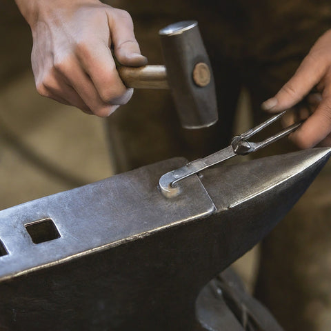 Image of craftsman personalizing a belt buckle
