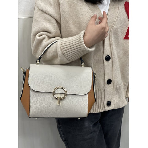 White Italian leather bag with brown trim worn on arm