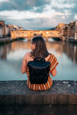 Woman travelling the world with her luxurious Italian leather backpack