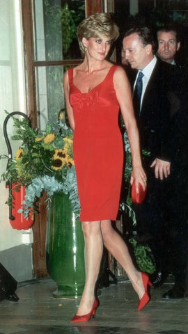 Princess Diana, a style icon wearing a sleek red dress to a royal function