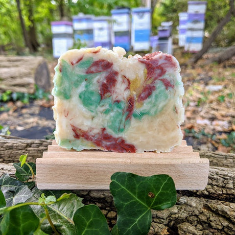 This rosemary honey and beeswax soap has swirls of red, green, ocher, and beige. It is scented with rosemary essential oil, and it makes a creamy and silky lather that leaves the skin moisturized. 