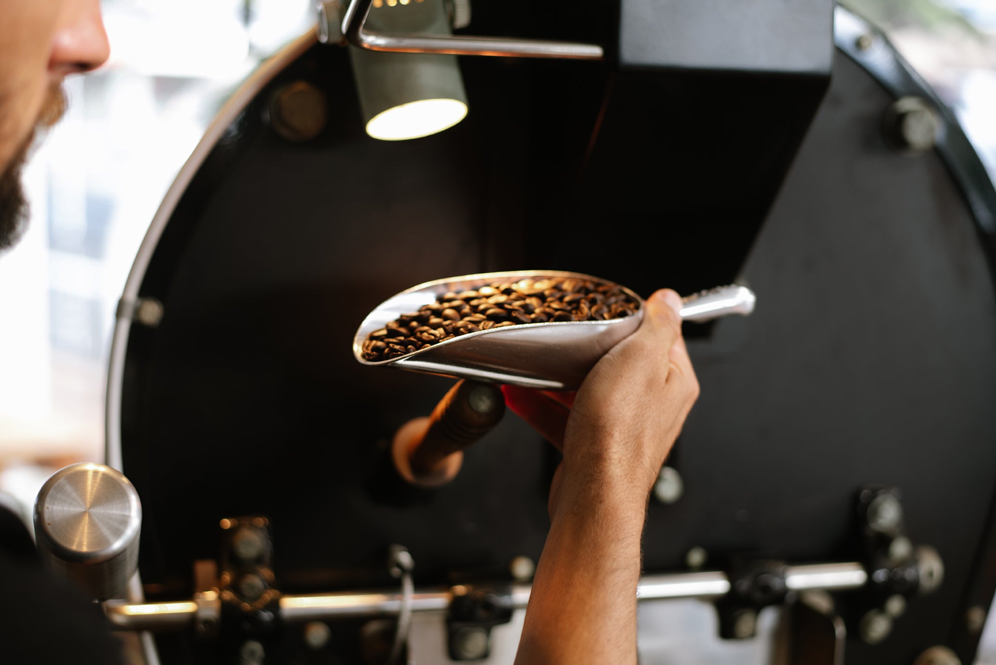 Danny Bolton inspecting coffee in the roasting process. PHOTO: Blake Wisz