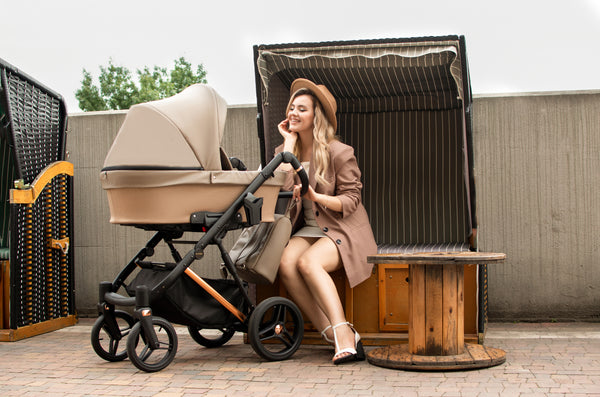 A woman sitting and looking at the Kunert Lazzio Stroller