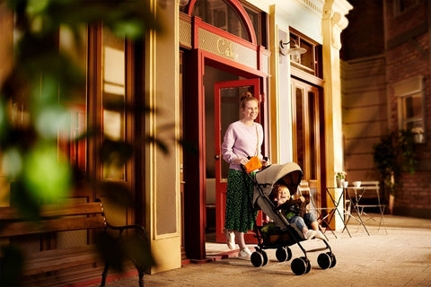 A Woman with a Kid inside the Kinderkraft Stroller SIESTA in Gray