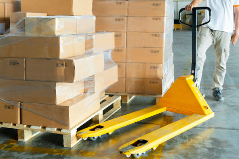 Yellow Teknomek pallet truck in action in a warehouse